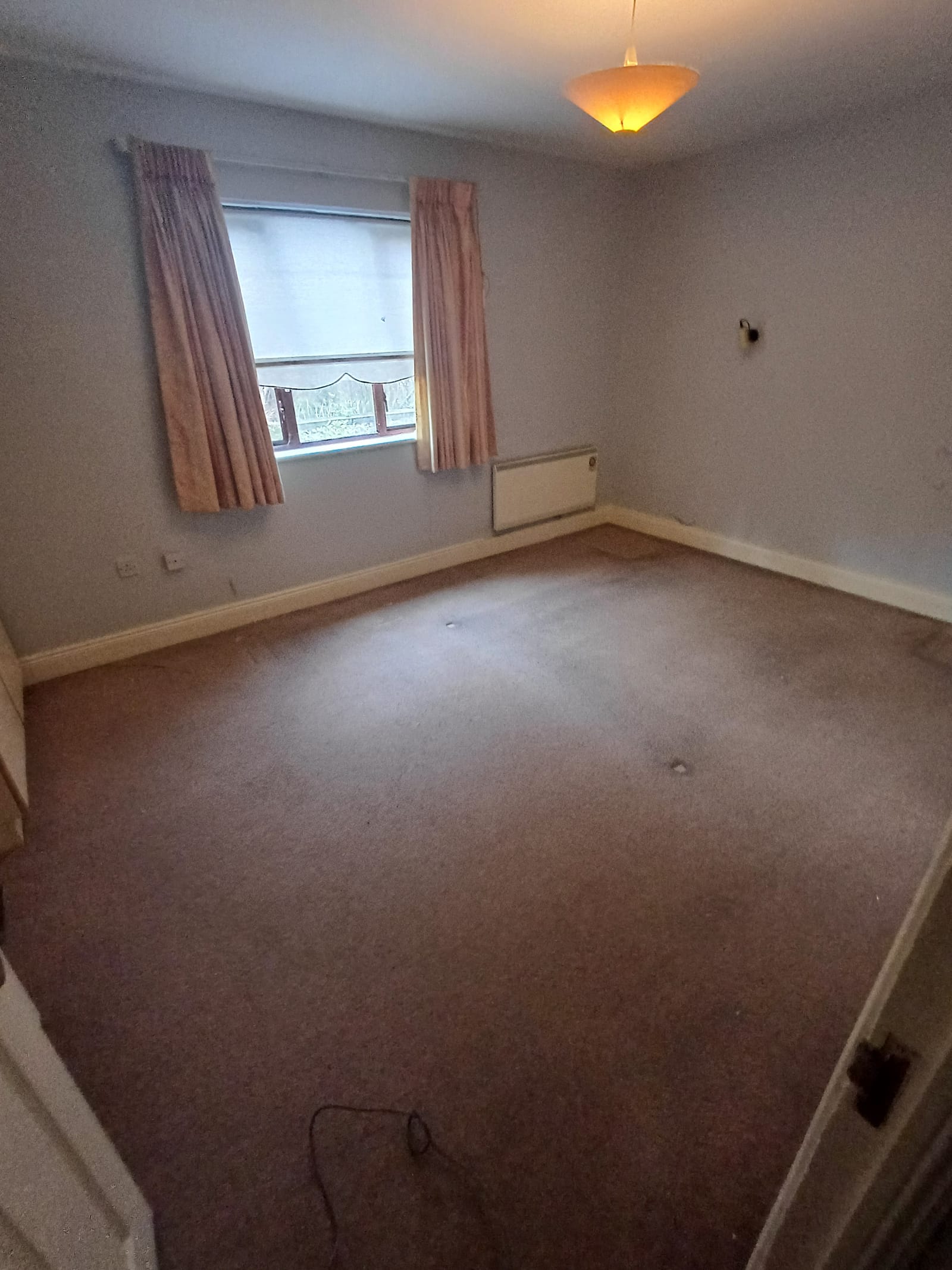 A bedroom left empty and cleared after a clearance