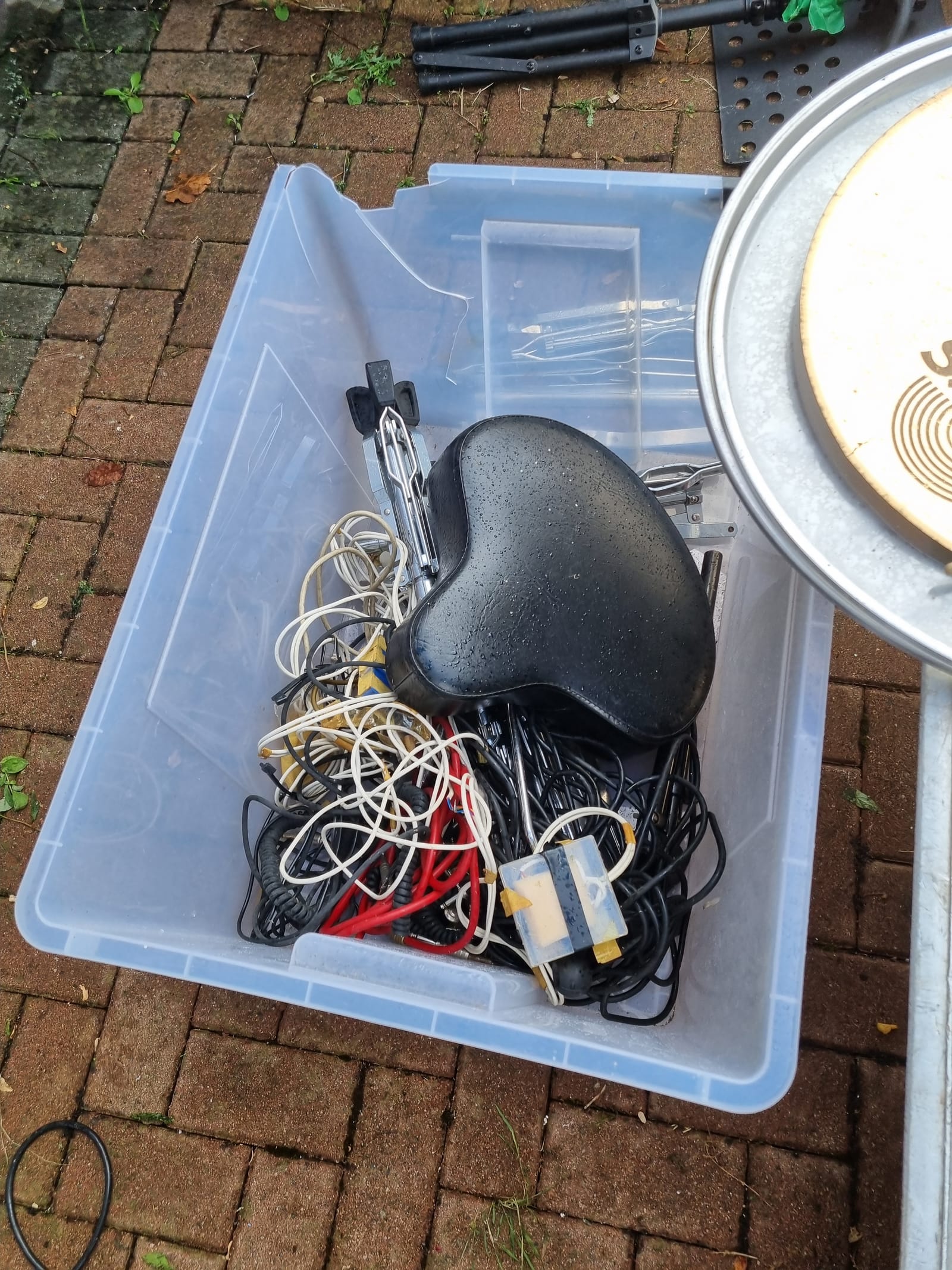 A storage bin of cables and tools cleared from a garage