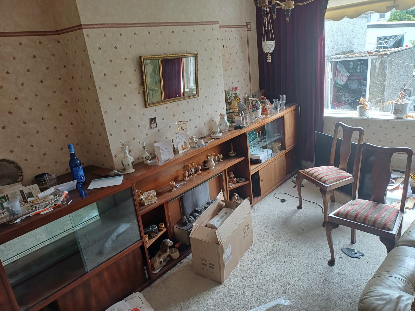 A living room display cabinet cleared during a house clearance