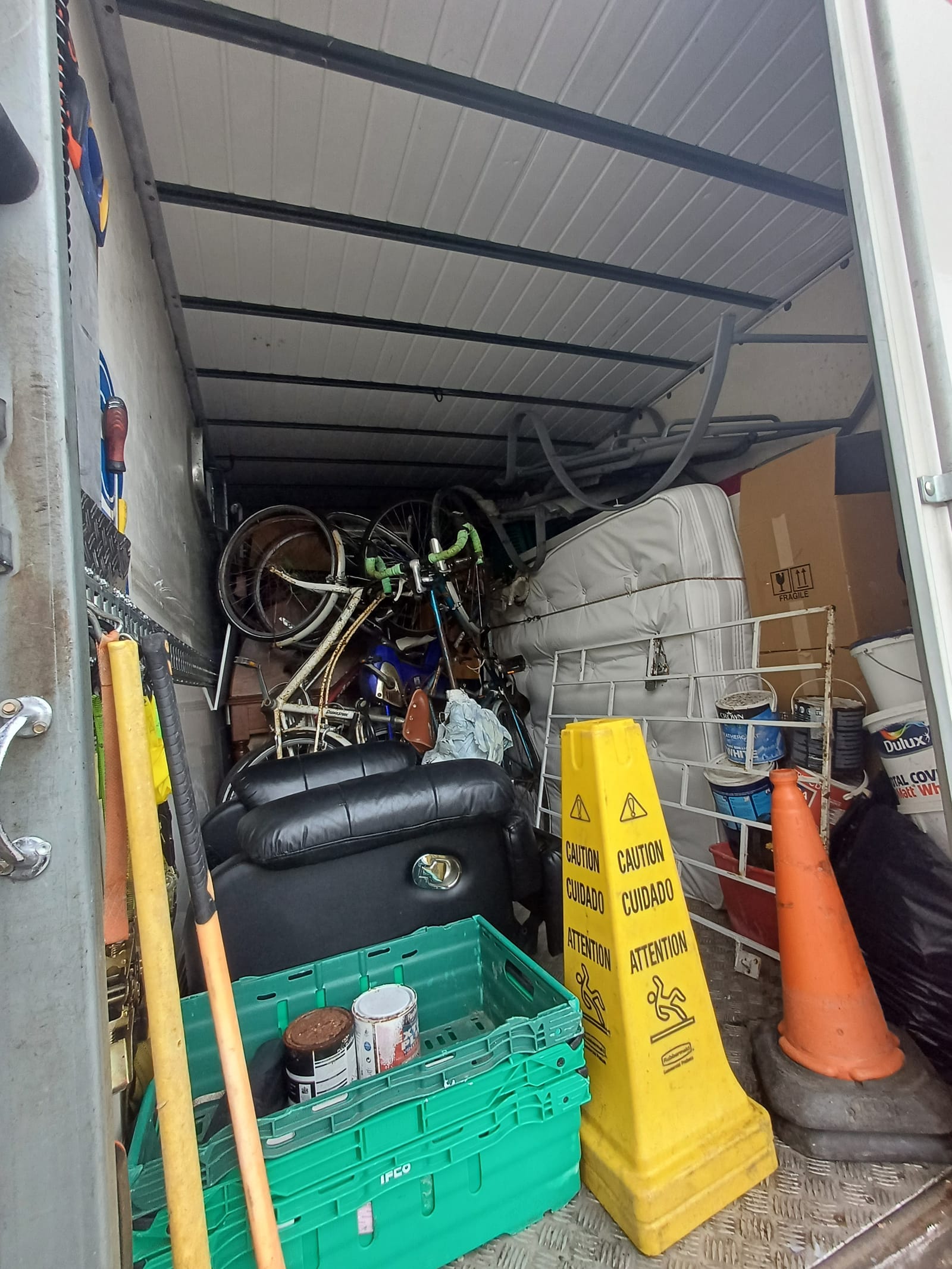 A van loaded with furniture and belongings during a clearance